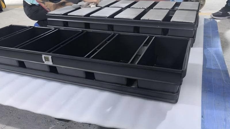 Welding a nameplate onto a pan A metal nameplate with a Data Matrix Code being welded onto a baking pan