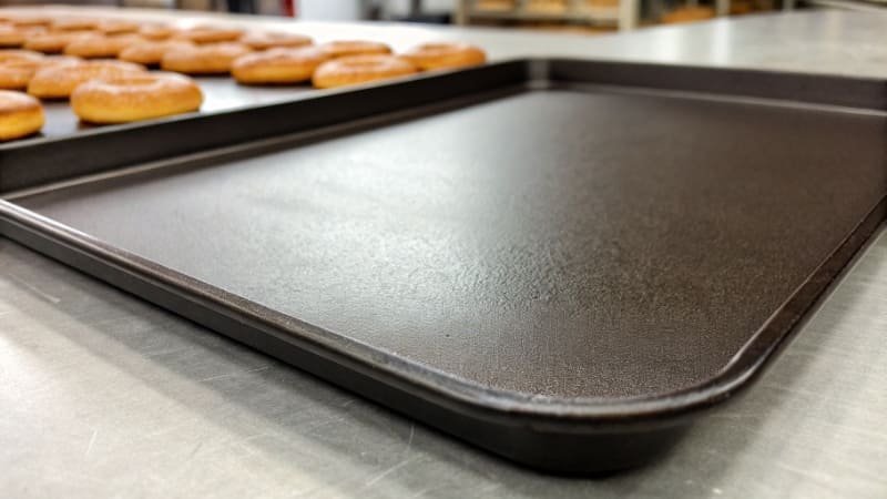 A close-up shot of a dark non-stick coating on a baking sheet.