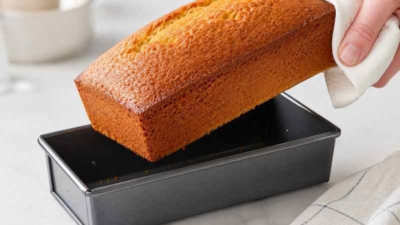 A close-up of a high-sugar cake releasing cleanly from a silicone-coated pan