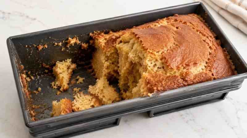 Baking Mistake with Wrong Pan Coating A damaged cake stuck to a baking pan