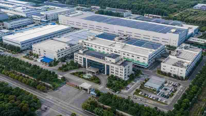 Factory Size and Production Capacity An aerial view of a large manufacturing plant with multiple buildings.