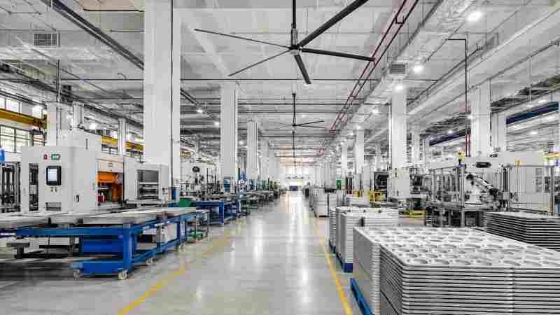 A photo of a modern, clean factory floor with advanced machinery